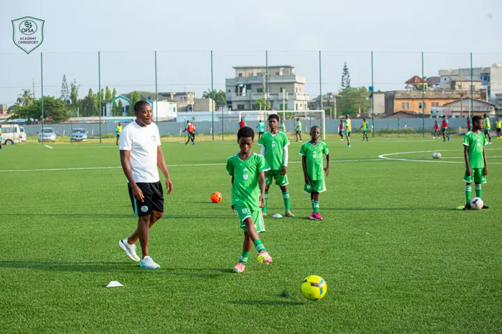 Séance d'entraînement : un encadrant guide de jeunes joueurs balle au pied